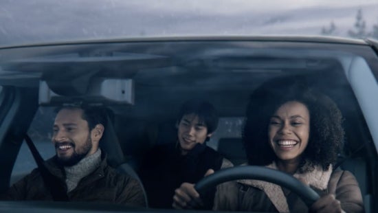 Three passengers riding in a vehicle and smiling | Nissan of Bowie in Bowie MD