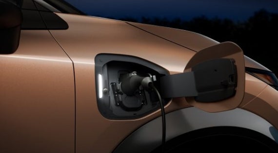 Close-up image of charging cable plugged in | Nissan of Bowie in Bowie MD